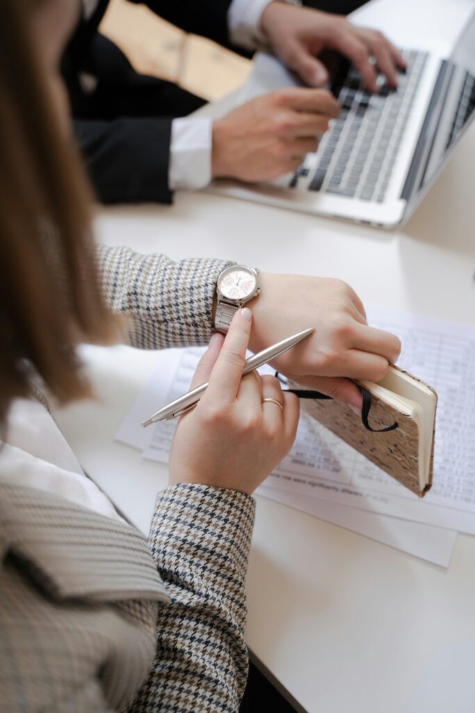 Professional woman checking her wristwatch, representing time management, productivity, and business efficiency.