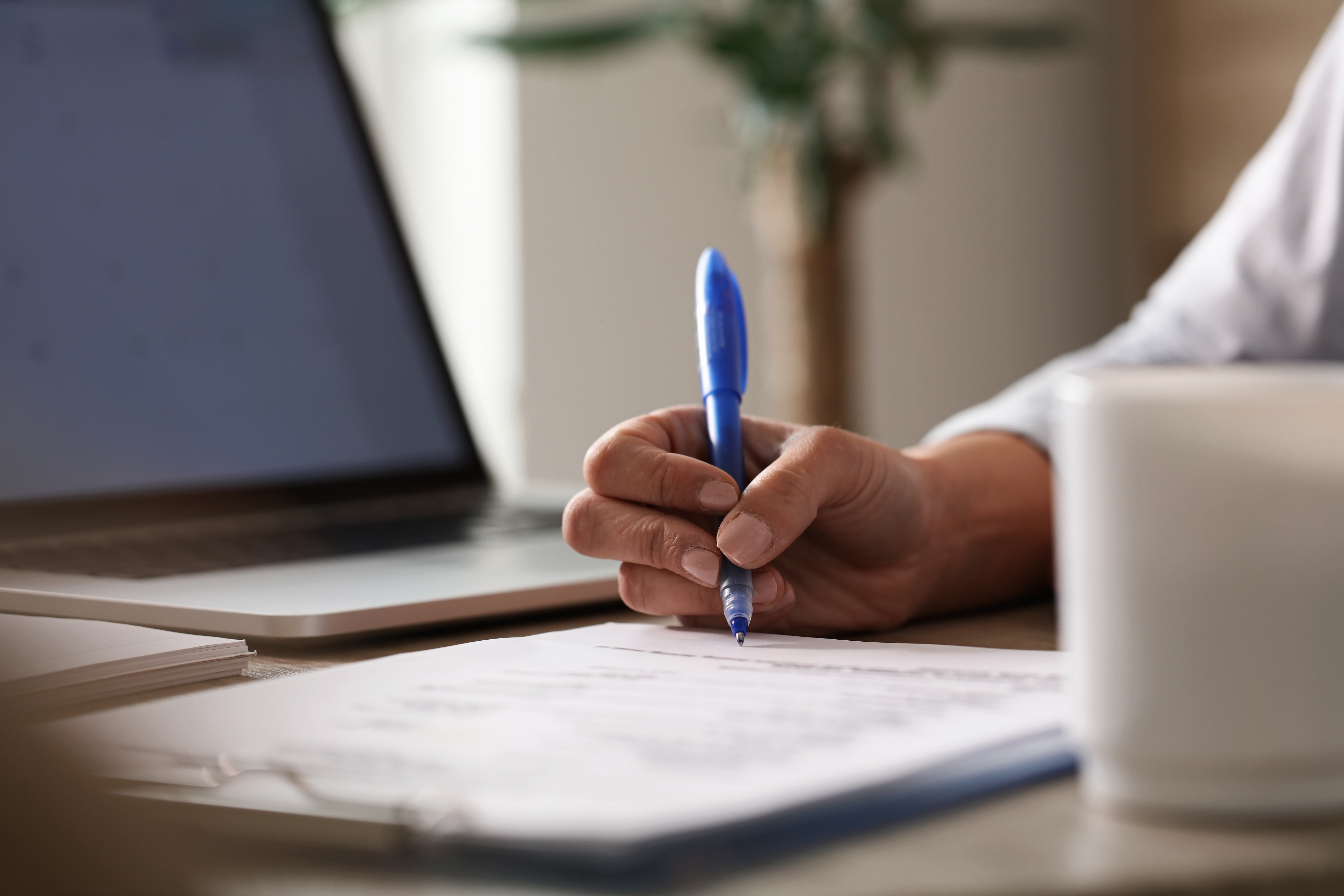 Professional taking notes, representing managed services strategy and IT contract planning.