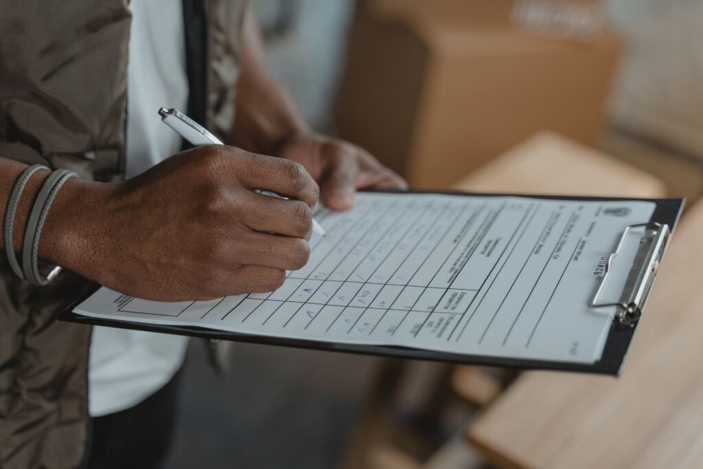 Professional taking notes during a meeting, representing business planning, IT strategy, collaboration, and decision-making.